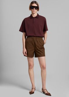 Color: Brown Midweight cotton blend fabric Regular fit Mini length Side seam pockets Elasticated waist Slip-on style Unlined Dry Clean Imported Relaxed Fit Short Tops With Pockets, Relaxed Fit Tops With Pockets, Short Length, Short Tops With Pockets And Relaxed Fit, Relaxed Fit Tops With Elastic Waistband For Work, Casual Workwear Shorts With Straight Hem, Modern Cotton Shorts With Pockets, Modern Cotton Bottoms For Daywear, Denim Suit, Paris Woman