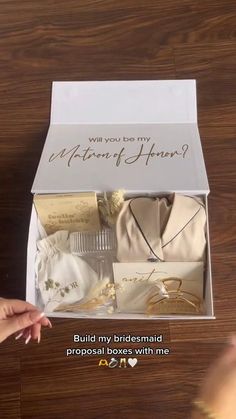 someone is opening the box with their wedding gifts in it and there are other items inside