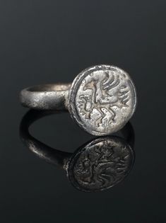 Warrior Bird. Bird with Raised Wings. Original Antique Ring by AntiqueJewls. Antique Signet Ring. Medieval Engraved Ring. Antique Ring. Ancient Artifact. Unique Ancient Jewelry. 1400-1600s Bronze, patina. Medieval ring with a large bird with raised wings. A bird with a thick neck and a powerful beak. Ring with a round shank and a circular bezel with a furrow along the border. Round in section. Antique Engraved Intaglio Ring, Antique Etched Engraved Round Ring, Antique Engraved Round Band Ring, Byzantine Engraved Ring For Anniversary, Byzantine Engraved Round Ring For Anniversary, Byzantine Engraved Anniversary Ring, Ancient Ceremonial Round Rings, Ancient Ceremonial Hallmarked Jewelry, Ceremonial Antique Rings With Antique Finish