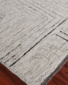 a close up of a rug on a wooden floor with wood floors and white carpet