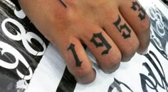 a hand with numbers tattooed on it