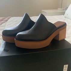 Black Heeled Clogs. Never Worn. Size 8. 2.5” Heel. Chic Open Heel Clogs For Workwear, Open Toe Clogs With Removable Insole For Work, Modern Black Mules With Stacked Heel, Synthetic Mules With Wooden Block Heel, Workwear Clogs With Reinforced Block Heel, Chic Clogs With Stacked Wedge Heel, Synthetic Mules With Stacked Heel For Work, Modern Synthetic Clogs With Open Heel, Modern Open Heel Synthetic Clogs