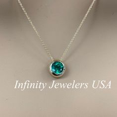 "The pendant pictured is a lab created emerald #6750 Video shows 14k White Gold -Approximate total carat weight: approx. 1.00ctw diamond equivalent -Center Stone Size: 6.5mm - approx. 1.00ct diamond equivalent -Center Stone Shape: round -Gem Type: lab created emerald -Stone Clarity: VS2 -Stone Color: lively rich green -Moh's Scale: 8.5 hardness -Metal Type and Purity: 14k yellow gold -Setting: bezel set floating necklace -Chain: delicate 14k gold chain / heavier option with lobster claw availabl Round Gemstone Solitaire Necklace In Fine Jewelry Style, Formal Jewelry With Tension Setting In Round Pendant, Formal Round Pendant Jewelry With Tension Setting, Fine Jewelry With Bezel Setting For May Birthstone, Fine Jewelry Round Birthstone Necklace With Bezel Setting, Formal Round Birthstone Necklace In Fine Jewelry Style, Anniversary Jewelry With Bezel Set Round Pendant, Anniversary Bezel Set Round Pendant Jewelry, Elegant May Birthstone Jewelry With Tension Setting