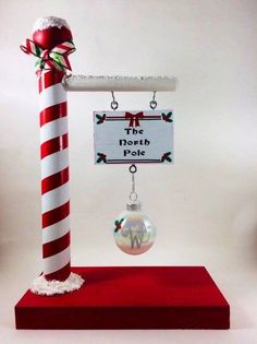 a red and white pole with a christmas ornament