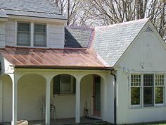 a white house with a red tin roof