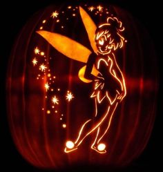 a carved pumpkin with an image of tinkerbell on it's face and stars