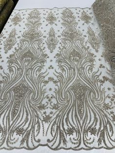 a white table cloth with silver sequins on it