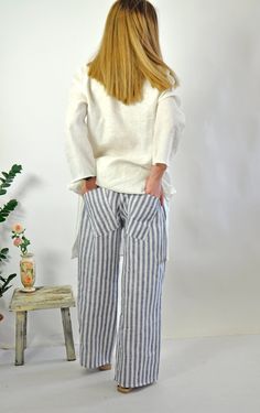 "Natural Linen White pants. Summer Loose Drop crotch Pants. Loose asymmetric linen pants. Every day comfortable pants. Maxi trousers. Cool casual pants. Striped 100% lINEN pants. Comfortable and Relaxed. Zipped pants. The style I used was originally designed and professionally constructed by me. Each item of my shop has a special package. Handmade in a pet-free and smoke- free environment. Model on picture is wearing size S Size chart Gabyga: XS (US 2, UK 6) Bust: around 33.5\" / 85 cm Waist: ar Baggy Linen Bottoms For Vacation, Beach Linen Harem Pants With Pockets, Beach Harem Pants With Pockets In Linen, Baggy Linen Beach Pants, Flax Bottoms With Pockets For Beach, Vacation Linen Harem Pants With Loosely Fitted Hips, Loosely Fitted Linen Harem Pants For Vacation, Ankle-length Linen Harem Pants For Vacation, Linen Pants With Pockets