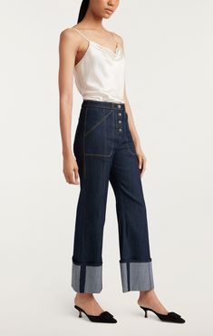 Make a modern statement in the Cuffed Benji Pants. Crafted from an elevated Denim Indigo fabric, these cropped trousers are perfect for any occasion with their utilitarian pockets and striking flared fit. Button fly and cuffs give this piece a modern feel, making you look chic and sophisticated. Details Button flyFabric: Indigo DenimHigh risePatch pocket detailCropped Content and Care 77% Cotton 21% Polyester 2% ElastaneDry Clean OnlyImported Measurements 29in inseamMeasurements from size 4 Dyes Indigo Fabric, Indigo Colour, Denim Chic, High Hips, Cuffed Pants, Parisian Chic, Cropped Trousers, Cropped Denim, Look Chic