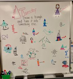 a white board with writing on it in front of a classroom wall that is decorated with drawings and magnets