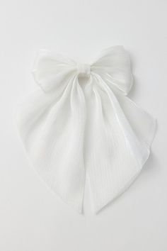 Add a femme touch to your look with this satin hair bow. Finished with a spring barrette backing. Features Satin hair bow barrette Coquette cool hair bow Soft satin bow Draped silhouette Spring barrette backing Content + Care Mixed metal, polyester Spot clean Imported | Draped Satin Hair Bow Barrette in White, Women's at Urban Outfitters White Ribbon In Hair, White Hair Accessory, Satin Hair Bow, Dream Wishlist, Hershey Kiss, 2024 Wishlist, Cool Hair, Bow Barrette, Dream Party