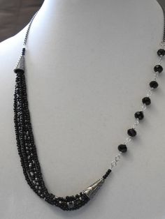 Boho Hippie  OOAK Black and Silver Crystal and Seed Bead Necklace with black bead caps and chain. Lobster clasp closer. by NoresanDesigns on Etsy Silver Multi-strand Beaded Necklace With Black Beads, Black Multi-strand Necklace With Silver Beads, Black Multi-strand Necklace With Faceted Beads, Adjustable Black Beaded Crystal Necklace, Silver Onyx Beaded Necklace With Black Beads, Black Onyx Beaded Necklace With Faceted Beads, Black Beaded Necklaces With Lobster Clasp, Asymmetrical Jewelry, Czech Beads Jewelry