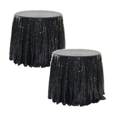 two black tablecloths with silver sequins on them, one is round