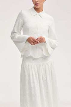 Indulge in effortless luxury with our Halima White Eyelet Top. This elegant button down top features delicate eyelet fabric and scalloped hem detailing, perfect for your next seaside escape. Embrace sophistication and style with every wear. Model is 5'7" and is wearing size XS. White Eyelet Top, White Dress Formal, Dresses Flowy, Nikkah Dress, Eyelet Fabric, Eyelet Top, Engagement Dresses, Kids Outerwear, Dress Satin