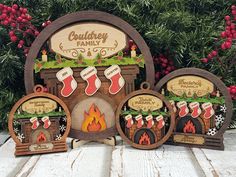 three wooden christmas decorations sitting on top of a table