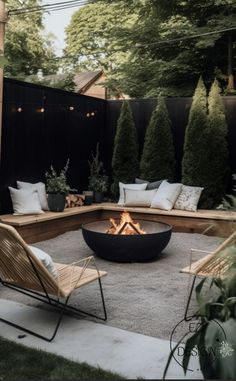 an outdoor fire pit surrounded by chairs and tables in the middle of a backyard area