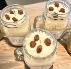 three mason jars filled with whipped cream and nuts