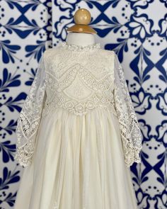 A unique and exquisite full vintage lace gown. Beautiful hand-embroidered lace in ivory. It has three clip-on on the back for closure. Does not include bonnet Made in Spain 100% polyester Dry Cleaning Final Sale, no exchanges nor returns are available White Lace Dress With Lace Bodice For Ceremonies, White Lace Dress With Fitted Bodice And Lace Sleeves, Cream Baptism Dress With Lace Bodice, Elegant Lace Patchwork Dress For Ceremony, Elegant Dresses With Lace Patchwork For Ceremony, Cream Party Dress With Delicate Lace, Elegant Cream Lace Dress With Lace Trim, Elegant Cream Lace Dress With Lace Sleeves, Elegant Cream Lace Dress With Delicate Lace