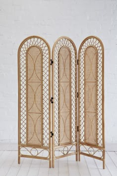 three - panel bamboo screen with intricate carvings on the top and bottom, each side open