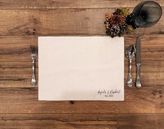 the place setting is ready to be served with silverware and an empty white napkin