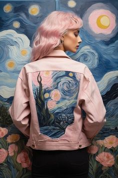 a woman standing in front of a painting wearing a pink jacket with an image of the starry night on it