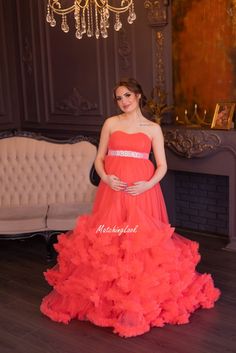 Maternity Gown For Photosession, Tulle Ruffled Maternity Dress, Pregnancy Dress  Coral Maternity ruffled tulle puffy dress designed for the most beautiful maternity photos.  Strapless pregnancy dress is tailored of more than 50 metres of soft tulle, has adjustable corset upper for S-L size. Sash is included.  #PregnancyDress #MaternityBallGown #PhotoPropsDress #MaternityPhotoshoot #TulleRuffledDress #MaternityDress #MaternityGown #CoralMaternityDress #BabyShowerDress #MaternityTulleGown Floor-length Maternity Dress With Ruffles For Wedding, Floor-length Ruffled Maternity Dress For Wedding, Tulle Dress With Ruffles For Bridal Shower, Wedding Maternity Dress With Ruffles, Red Floor-length Maternity Dress, Fitted Red Maternity Dress For Wedding, Wedding Maxi Dress With Ruffles And Empire Waist, Maternity Tulle Dress With Ruffles, Wedding Maternity Dress With Ruffles In Tulle