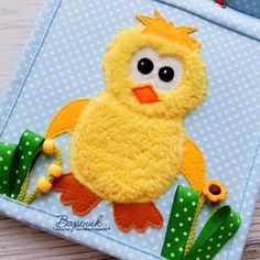 a close up of a stuffed animal on a wooden table with polka dotes and green ribbon