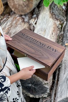 a woman is holding a wooden box that says happy birthday