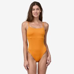 Our bandeau-inspired, reversible one-piece swimsuit has a versatile strap system that can be worn tied over the shoulders or crossed in back for a more secure fit. Made in a Fair Trade Certified™ factory. | Patagonia Women's Reversible Sunrise Slider One-Piece Swimsuit in Kishu Orange, Large - Surf Swimwear - Recycled Nylon/Recycled Polyester/Spandex Summer Bandeau Bodysuit With Built-in Bra, Beach Nylon Bodysuit With Straps, Nylon Straps Bodysuit For Beachwear, Summer Swimming Bodysuit With Straps, Solid Color Swimwear With Straps For Sunbathing, Summer Swimwear With Built-in Bra And Tank Straps, Nylon Straps Bodysuit For Swimming, Summer Strappy Back Solid Color Bodysuit, Summer Bodysuit With Strappy Back