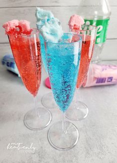 three glasses filled with different colored liquids and ice cream on top of each glass