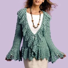 a woman wearing a green cardigan with ruffles and beads on her necklace