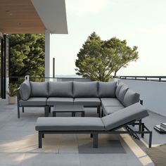 an outdoor couch and chaise lounge set on a patio