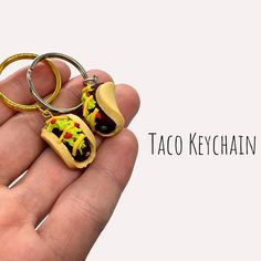 there is a tiny taco keychain in someones hand