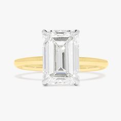 an emerald cut diamond in yellow gold