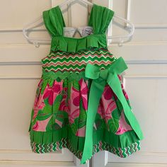 Super Cute And Colorful Sundress. Wide Straps. Tiered Skirt. Green Rickrack Waist Trim. Green Grosgrain Ribbon Bow. Keyhole Back With Button Loop Close. 100% Cotton. Machine Wash. New And Never Worn. Pet And Smoke Free Home. Ls70145 Green Ruffled Dress For Holiday, Playful Ruffle Twirl Dress For Play, Playful Ruffled Twirl Dress For Play, Playful Ruffled Dresses For Holidays, Playful Ruffled Holiday Dresses, Playful Holiday Dresses With Ruffles, Pink Twirl Dress With Ruffle Hem For Playtime, Pink Cotton Twirl Dress With Ruffle Hem, Green Cotton Dress For Babies