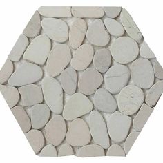 a white hexagonal tile with small rocks on it