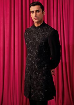 Step into the spotlight with our Black Floral Embroidered Sherwani Set. This exquisite ensemble features a heavily embellished achkan, adorned with large geometrically hand-embroidered floral work. Paired with a kurta and bell-bottom pants, it exudes elegance and sophistication. Perfect for weddings and festivals, this sherwani set will make you the centre of attention. Ideal for grooms and members of the groom's family, this set is sure to impress. Composition : Jacket, Kurta & Pants: Premium Suiting Care: Dry Clean Only and Vacuum Storage This product can be customized for sleeves, length of blouse and neckline Delivery : 4-6 weeks as the product is hand crafted. Check Size Guide or choose MySize for free customisation (All Sizes above XL can be made at 15% additional cost) For more info Traditional Semi-stitched Embellished Kurta, Traditional Embellished Semi-stitched Kurta, Festive Semi-stitched Embellished Sherwani, Traditional Embellished Transitional Kurta, Embroidered Fitted Sherwani For Reception, Festive Embellished Semi-stitched Sherwani, Traditional Embellished Kurta For Eid, Unstitched Embellished Traditional Kurta, Eid Reception Bandhgala With Intricate Embroidery