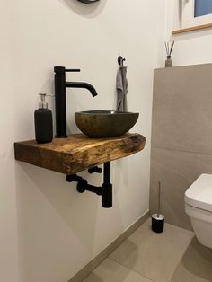 a bathroom with a sink, toilet and mirror on the wall next to each other