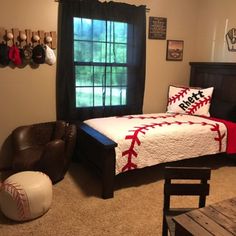 a bedroom with a baseball theme on the bed