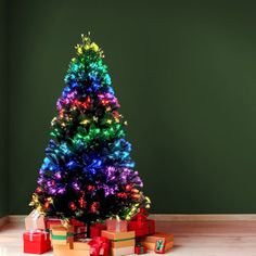 a brightly lit christmas tree surrounded by presents