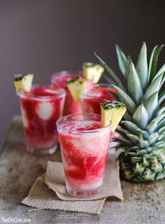 the frozen lava flow cocktail is served in glasses with pineapple wedges on top