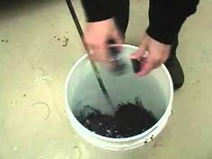 a person is stirring something in a bucket