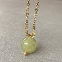 "UNIQUE GREEN JADE CRSYTAL CHAIN NECKLACE This necklace features a dainty, natural gemstone threaded on a 14k Gold Filled, Stainless Steel chain. Available in color options, this necklace is ideal for layering & makes the perfect gift! Please visit our store for other color options! Jade is believed to bring luck. Just like a four-leaf clover is considered a symbol of good fortune, jade is thought to have protective, lucky-charm energy.   ☆ Each of the stones we use to create necklaces were formed by nature over years. Each one is unique and beautiful just like nature itself.  We do not process or change our stones in any way, we accept their \"unique and raw\" beauties. We don't polish away \"flaws\" in the stones but rather leave them in their natural state.  Just like people, each stone Spiritual Green Jewelry With Adjustable Chain, Elegant Jade Crystal Necklace For Gift, Elegant Jade Crystal Necklace As Gift, Jade Jewelry For May Birthstone Gift, Jade Pendant Necklaces For Crafting, Elegant Jade Necklace With Adjustable Chain, Green Gemstone Bead Pendant Jewelry, Jade Gemstone Beads Necklace For Gift, Green Jade Jewelry With Adjustable Chain