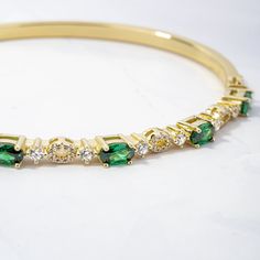 "This stunning emerald and cz bangle bracelet is super trendy and stylish! It's comfortable and lightweight. Looks great stacked or on its own!  - - - D E T A I L S - - - * We use a THICK plating of 14k Gold or Rhodium over 925 Sterling Silver  * Super high-quality & lightweight * Available in 6.25\", 6.75\" or 7\" * Latch Closure * 3mm thick  * Nickel-free & Hypoallergenic  BANGLES ON MODEL----> SOLID BANGLE https://www.etsy.com/listing/1553953045/bangle-bracelet-by-sami-jewels?click_key=f0f5ce3a5a09309ef8860b089ac71977a9c6f94f%3A1553953045&click_sum=b22f030f&ga_search_query=bangle&ref=shop_items_search_1&pro=1&frs=1&sts=1 DIAMOND STUDDED BANGLE: https://www.etsy.com/listing/1553953045/bangle-bracelet-by-sami-jewels Made with 100% Pure Love! ♡ Happy to answer any questions you may have! ? Gold Bracelet Bangle, Bracelet Emerald, Emerald Bracelet, Bracelet Minimalist, Bracelet Dainty, Dainty Bracelet, Vintage Bracelet, Minimalist Bracelet, Bracelet Vintage