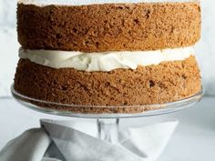 a cake with white frosting sitting on top of a glass plate