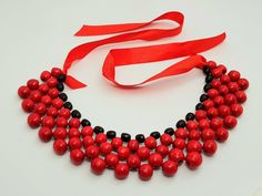 Beautiful wooden necklace. A wonderful accessory for the bride or bridesmaids or girls. Made of high quality materials, The perfect accessory and gift for any woman Handmade Color: red Handmade Red Bib Necklace For Party, Adjustable Red Necklaces For Wedding, Red Bib Necklace As Gift, Adjustable Red Necklace For Wedding, Red Wooden Bead Necklace As Gift, Red Wooden Beads Jewelry For Gift, Red Wooden Beaded Necklaces For Gifts, Red Wooden Beads Jewelry As A Gift, Red Wooden Beaded Necklaces As Gifts