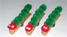 three green toothpicks with red noses and eyes are lined up in a row