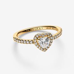 Tell the world you believe in love with our Elevated Heart Ring. A heart-shaped clear cubic zirconia sits at the centre of the ring accented by sparkling pavé in the frame of the setting and along the front of the band. - Pandora Elevated Heart Ring - 14k Gold-plated unique metal blend / Cubic Zirconia / Clear - Sz. 6 Quinceañera Rings, Pandora Elevated Heart Ring, Pandora Promise Rings, Elevated Heart Ring, Promise Rings Pandora, Pandora Ring, Believe In Love, Rings Jewelry Fashion, Tell The World