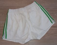 Original football shorts from 70's/80's era with cool retro design Designed in Western Germany 100% cotton Rare mint/unworn example of such a vintage shorts - please see photos Size on label: 5 - should fit well for men's S/M size Measurements: - waistband:      32cm - length:             30cm - leg opening:   29cm 7 Green Retro Cotton Shorts, Green Cotton Retro Shorts, Vintage White Cotton Shorts, Cotton Athletic Shorts With Three Stripes, Spring Cotton Shorts With Three Stripes, Vintage Green Cotton Shorts, Retro Cotton Athletic Shorts, Retro Cotton Athletic Shorts For Summer, Vintage Athletic Shorts For Summer