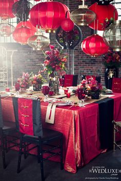 a table with red lanterns hanging from the ceiling